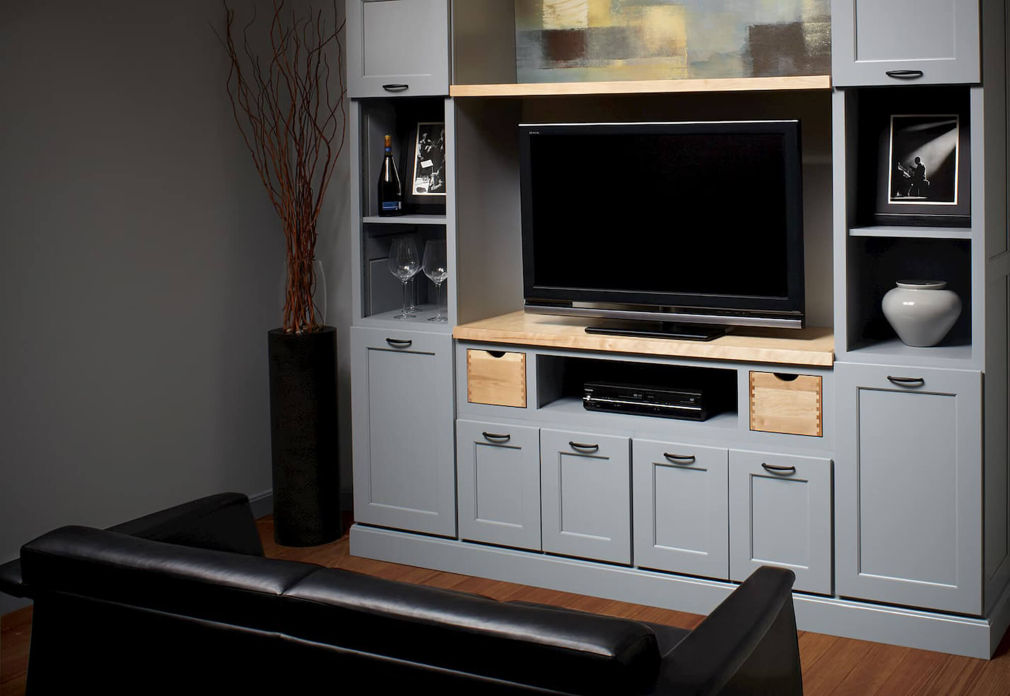 Grey painted entertainment center cabinets with lots of storage.