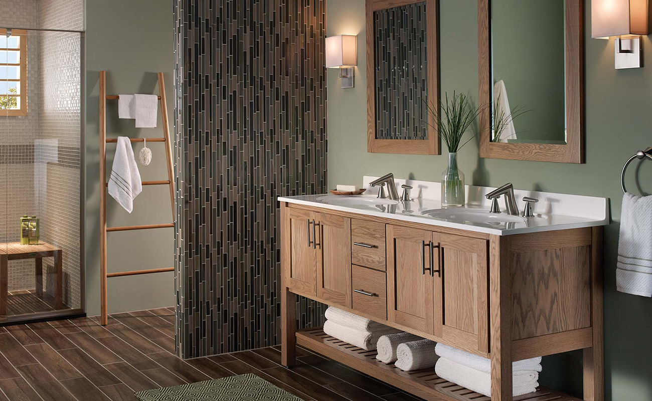 A sleek, transitional style bathroom with a spa-like design featuring a light stained wood vanity with a furniture style and an open shelf below.