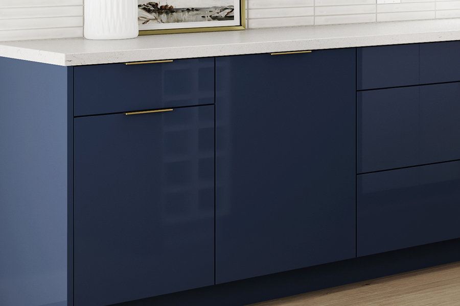 A close up of navy blue glossy acrylic cabinets with a contemporary slab cabinet door style.