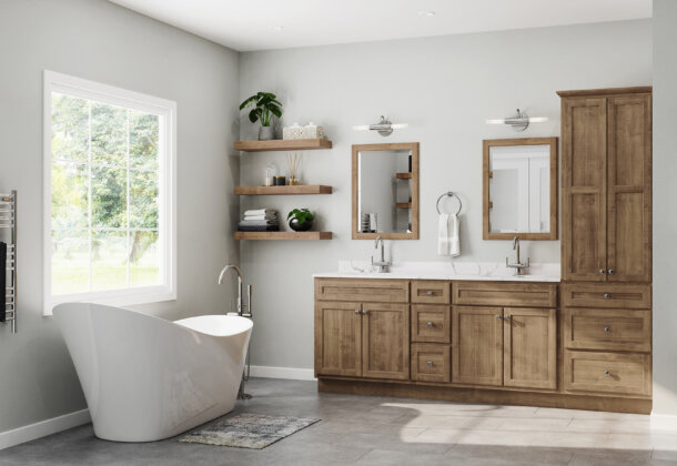 A transitional styled bathroom with light stained birch wood cabinets with a gray color palette.