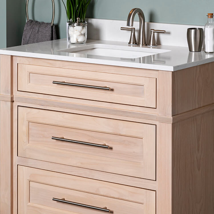 A light stained alder vanity with trendy modern stainless steel pulls.