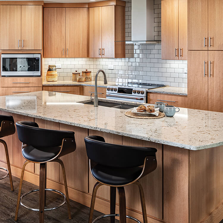 Soft, natural oak kitchen with modern slab cabinet doors and a large kitchen island.