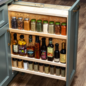 Easily organize your collection of spices and cooking oils with this pull-out spice rack cabinet from Bertch.