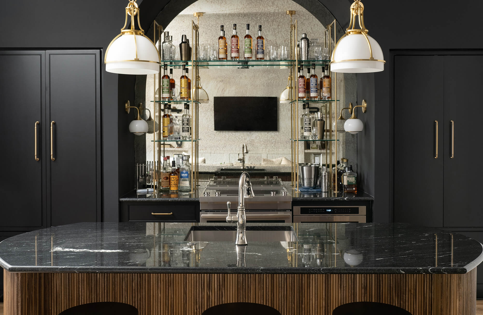 A black and wood home bar area with a moody atmosphere.