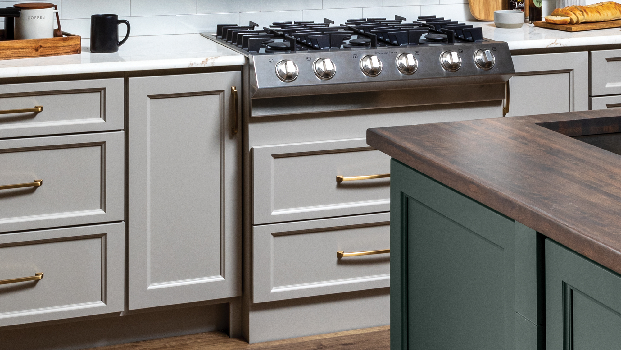 A close up of white and green painted cabinets with different sheen levels.