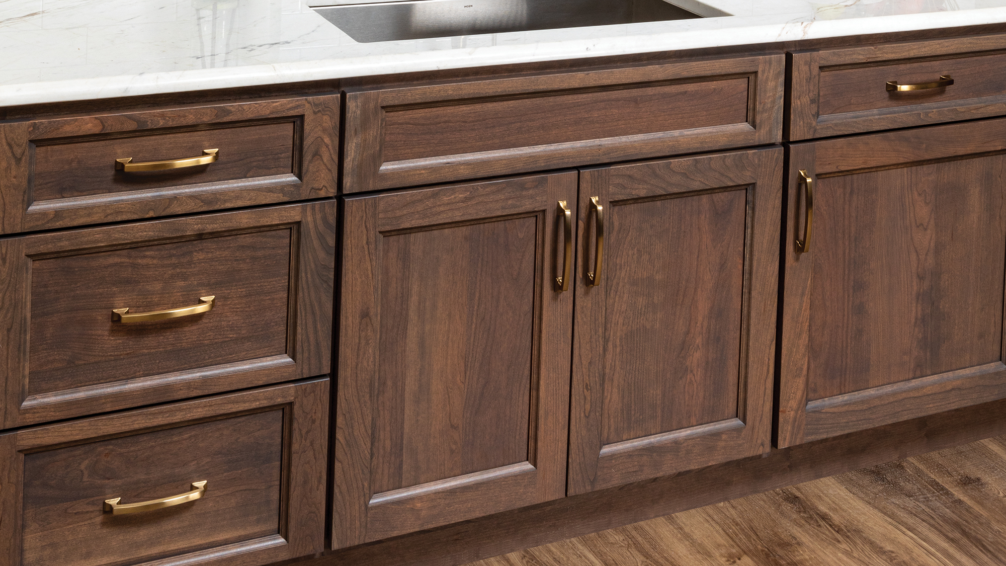 Different sheen options on stained wood cabinetry.