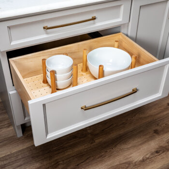 Bertch's Peg Board Drawer Organizer offers a convenient location below the countertop for stacks of plates and bowls.