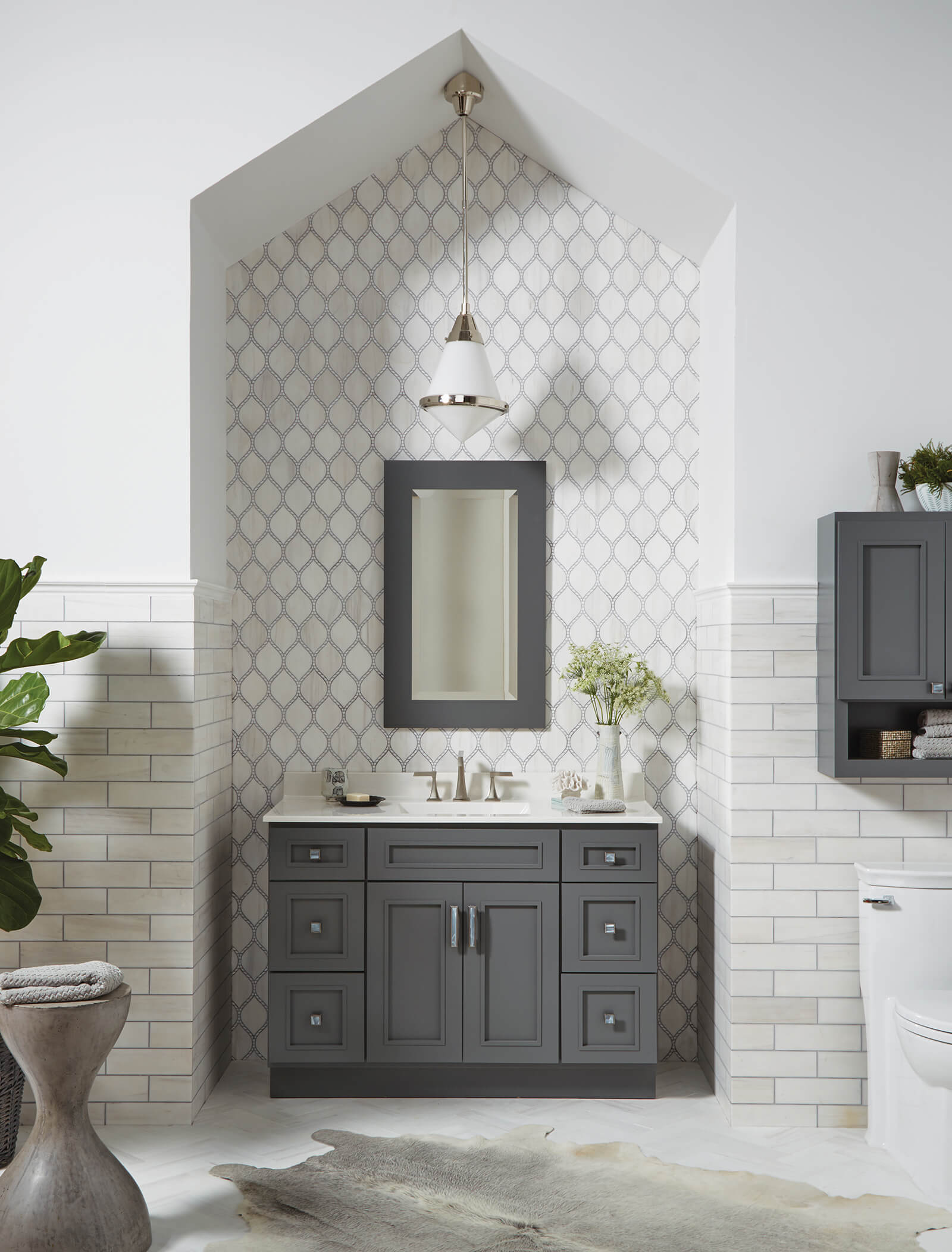 Grey bathroom vanity with matching framed mirror.