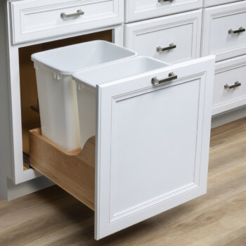 Easily separate your recycle items and trash using this pull-out 2 bin recycle center cabinet from Bertch Cabinet. 