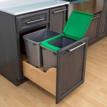 This pull-out cabinet offers 2 side-by-side wastebaskets, one with a lid to contain smells or store products like dog or cat food.