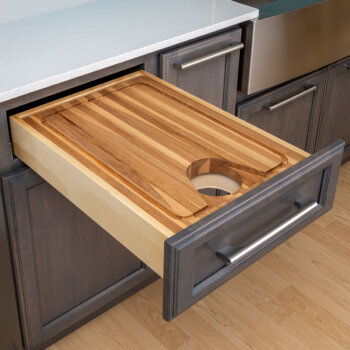 Our cutting board drawer works wonders over a Pull-Out Wastebasket or Recycling Center to streamline the food prep process.