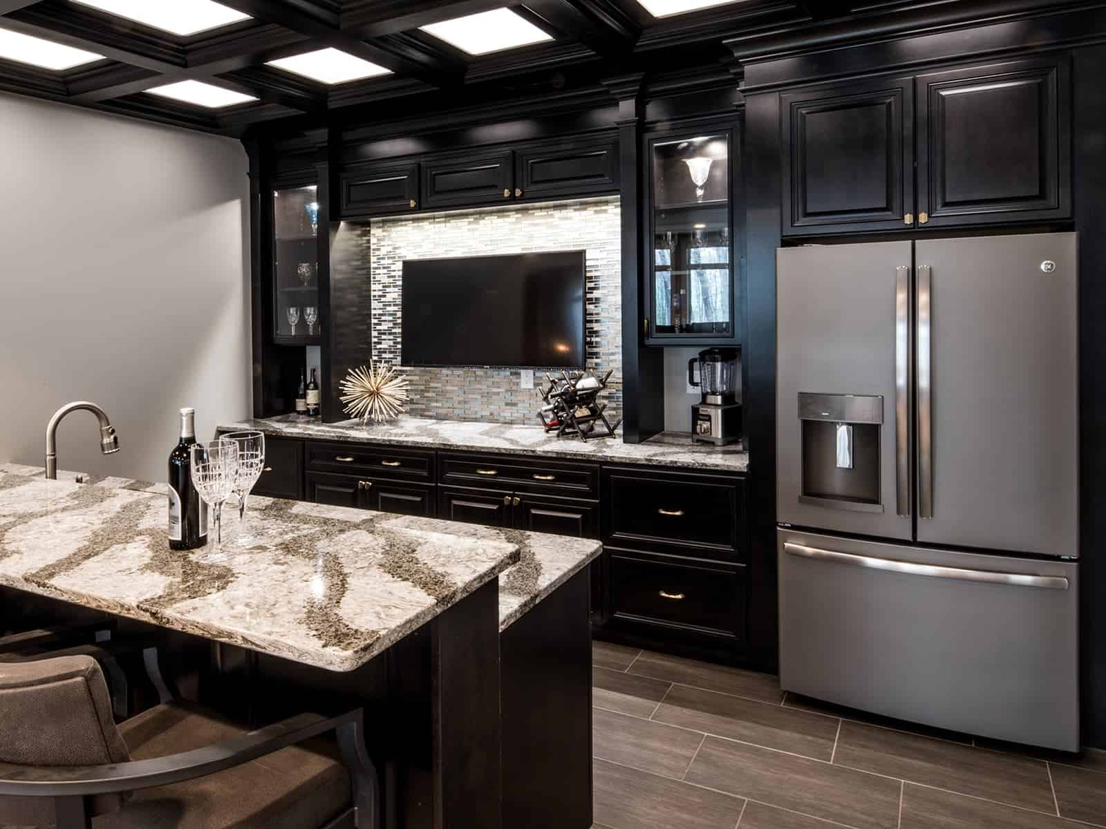 A dark stained ebony entertainment room and wet bar design.