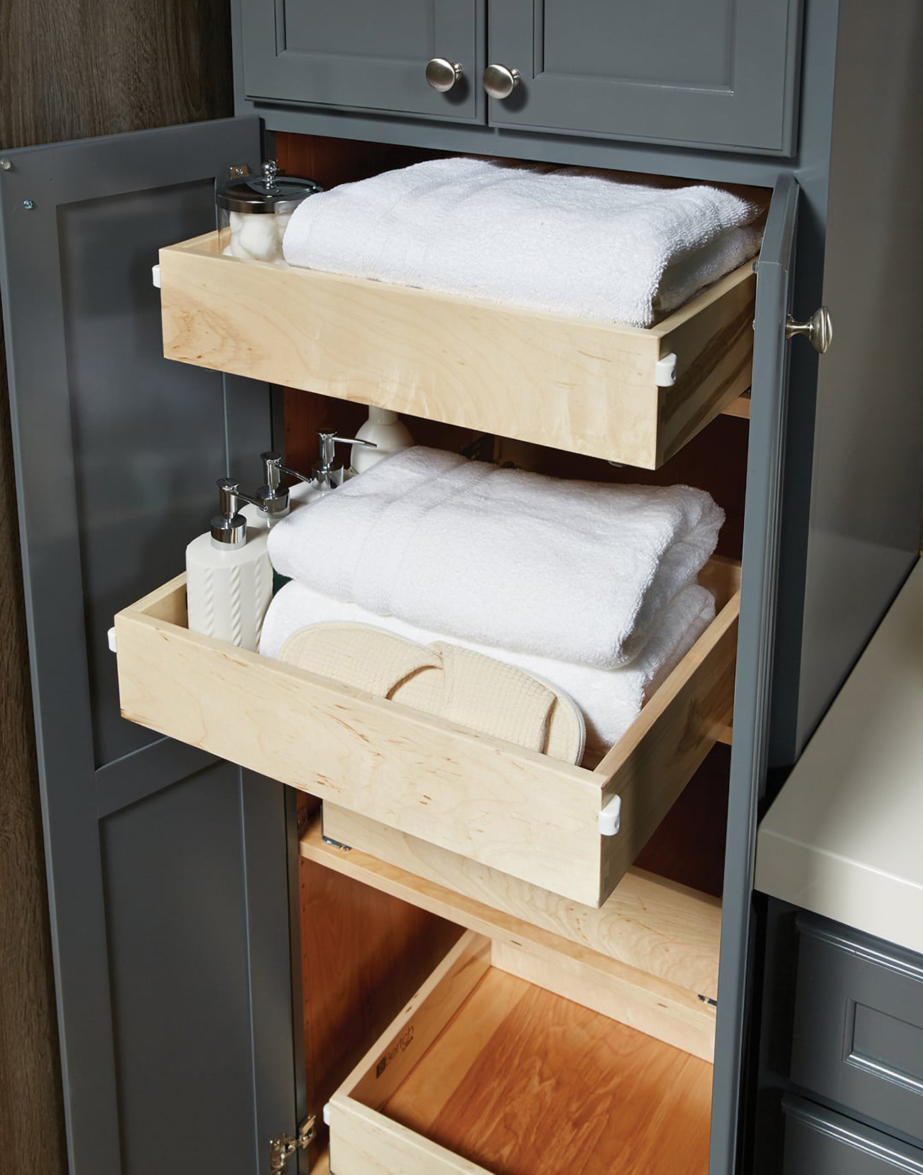 Roll-out shelf storage for organizing bathroom products and linens.