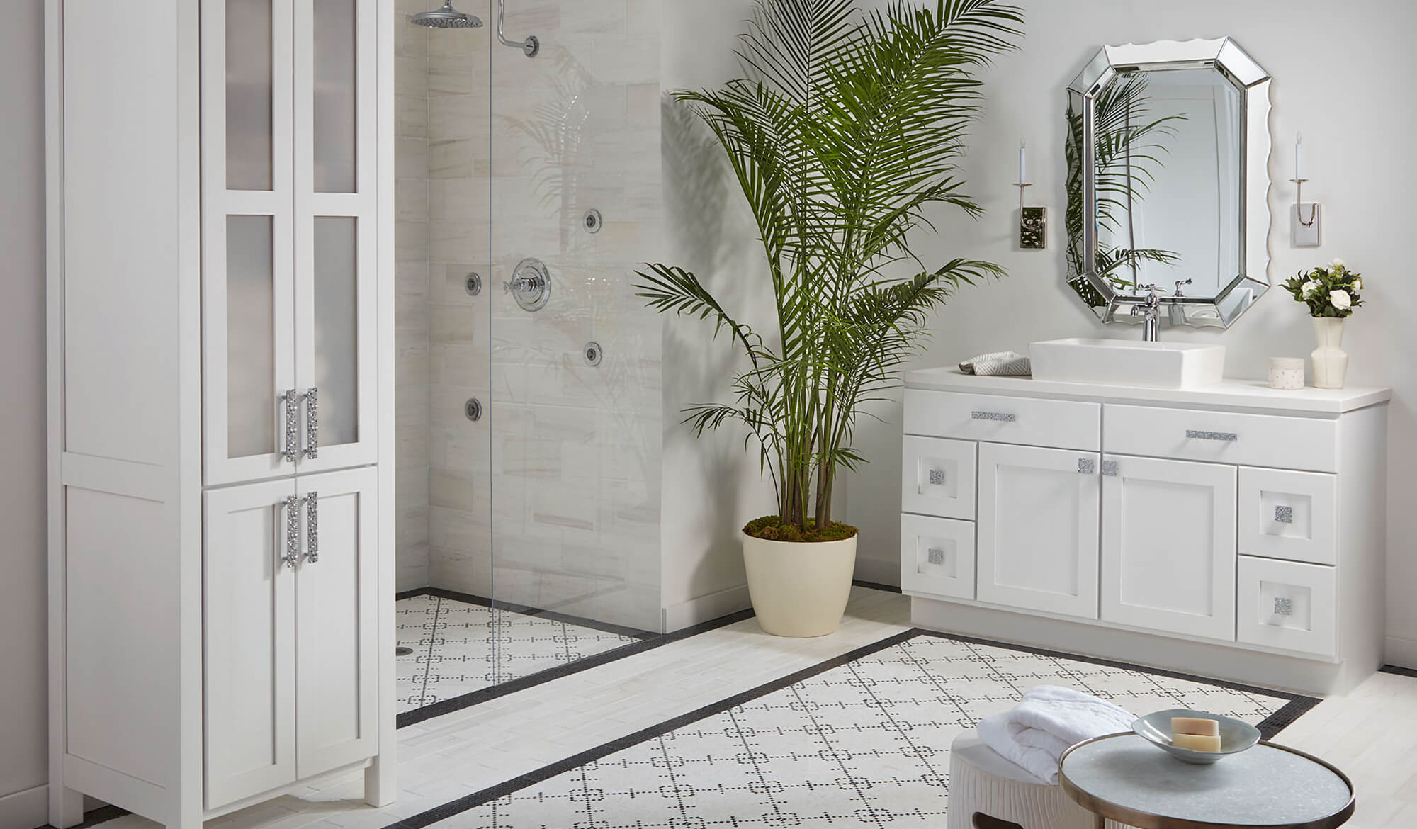 A stunning all-white bathroom design with pretty hardware and white painted bathroom furniture and cabinetry.