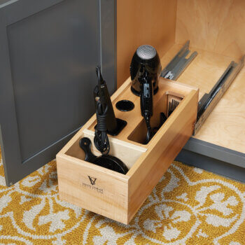 Customize your bath cabinets with storage accessory options. This roll-out includes two stainless steel cups to safely store curling irons.