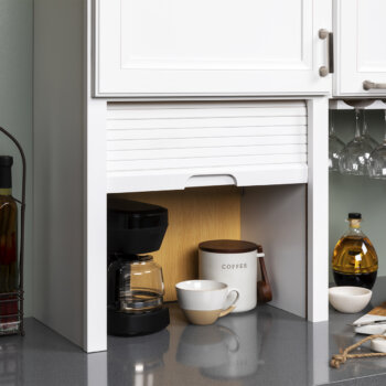 Stow away small kitchen appliances on the countertop using an easy-to-close and decorative tambour door by Bertch.