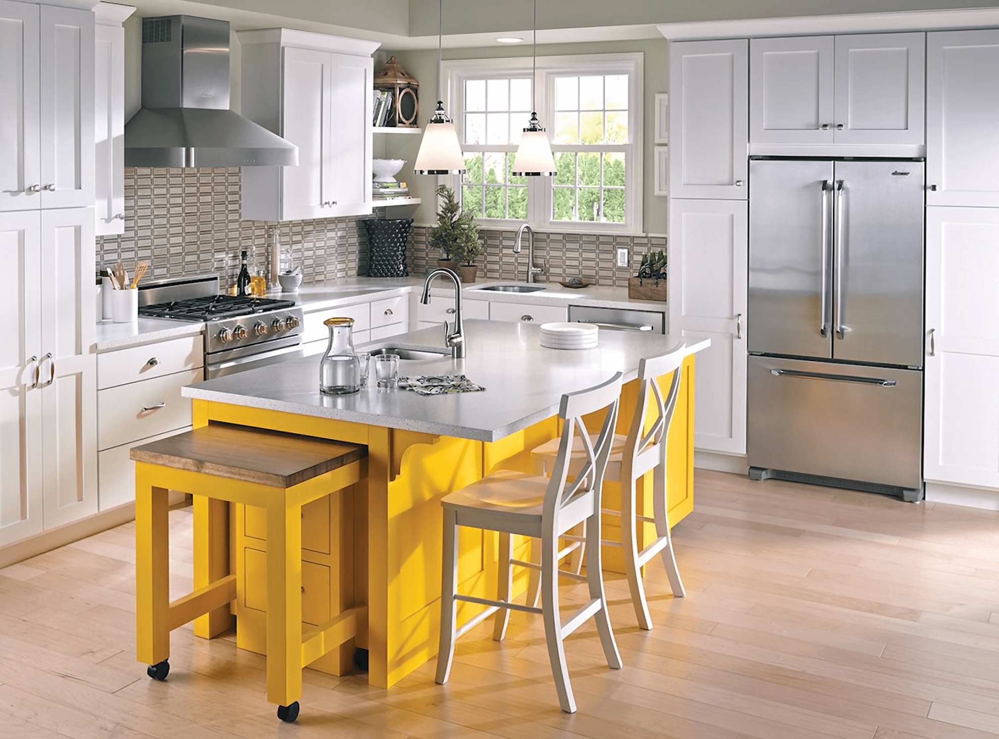 White kitchen with a bright yellow painted kitchen island. The island features an extra roll-out workstation.