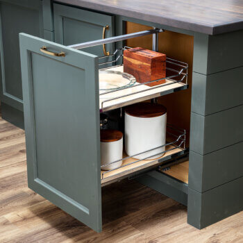 A pull-out under-the-counter storage cabinet from Bertch that features sleek, chrome rails works great for pantry & misc. kitchen storage.